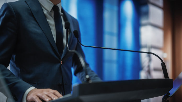 Close,Up,Of,A,Organization,Representative,Speaking,At,Press,Conference